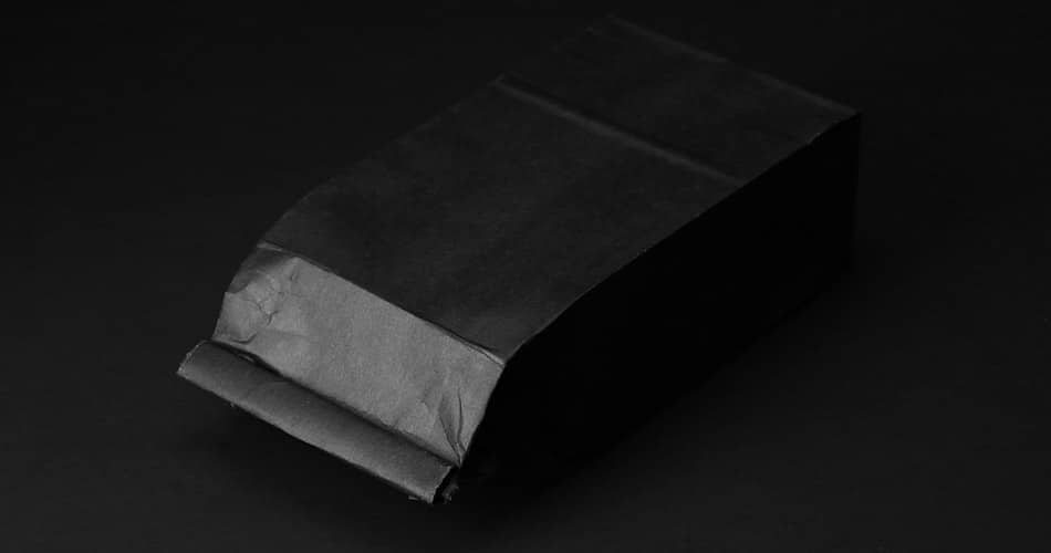 black tin tie bag laying down