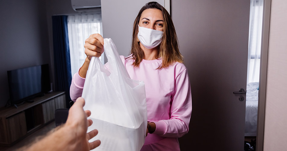 woman with mask and bag