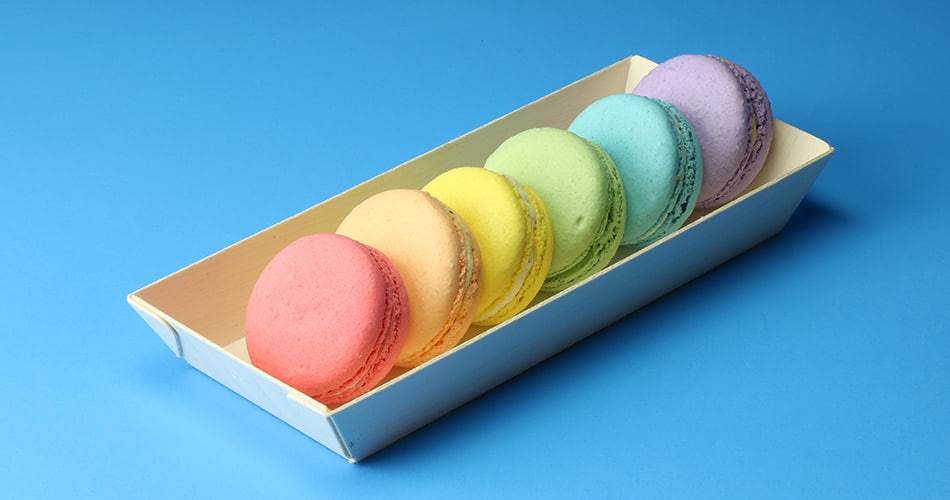 macarons in rectangular wooden disposable food tray